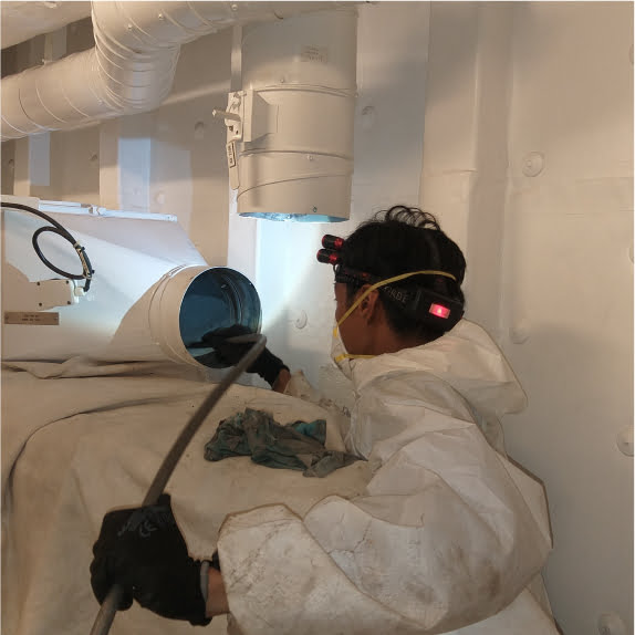 Operative wearing PPE paper suit, cleaning Hvac Air conditioning aboard a ship