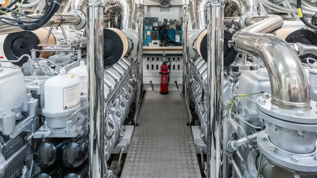 Yacht Refit Engine room of a superyacht featuring an array of plumbing and pipes