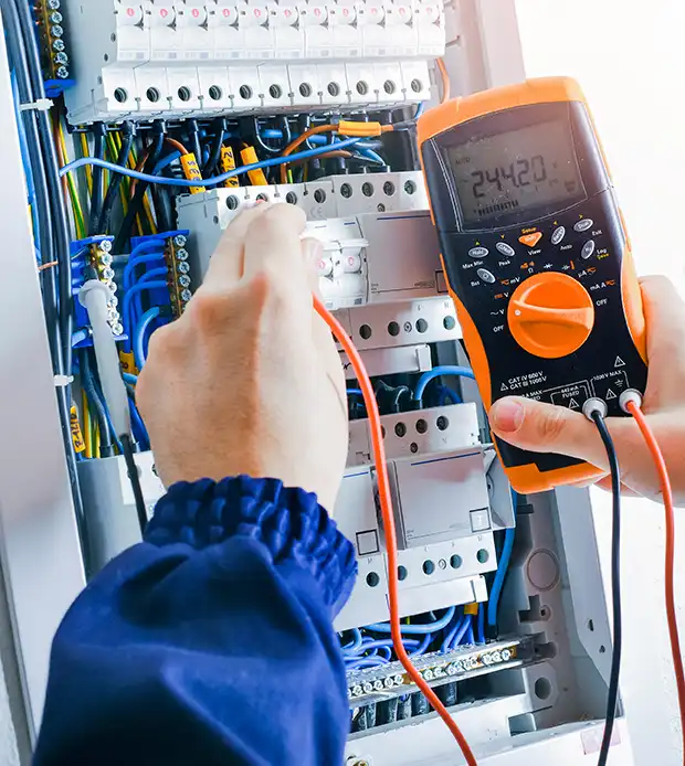 Yacht refit electrician using a meter to test vessel currents